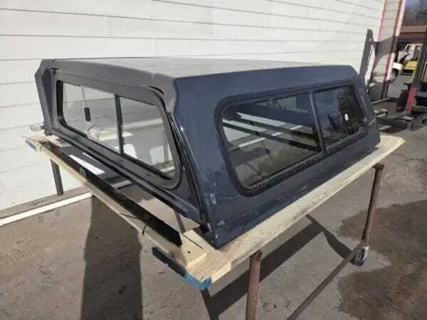 Premium LEER 100S truck cap for Toyota Tacoma with secure weather-resistant cargo protection.