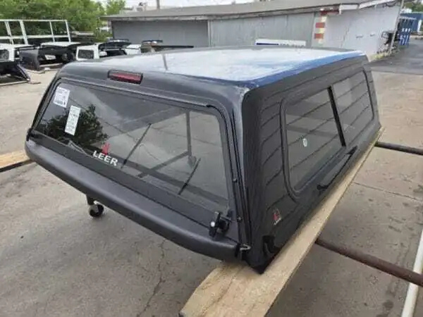 Toyota Tundra topper, LEER 100S truck cap, Toyota Tundra camper shell, fiberglass truck topper, truck bed cap, cargo protection, pickup truck accessories Premium LEER 100S truck cap for Toyota Tundra with secure storage and weather-resistant durability.
