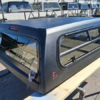 Premium LEER 100S Mile High Deluxe topper for Toyota Tacoma with elevated cargo protection. Toyota Tacoma topper, LEER 100S Mile High Deluxe, Toyota Tacoma camper shell, fiberglass truck topper, truck bed cap, cargo protection, pickup truck accessories
